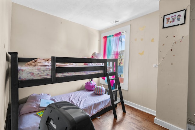 bedroom with a textured ceiling and hardwood / wood-style floors