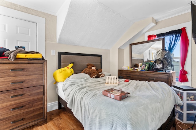 bedroom featuring lofted ceiling and wood-type flooring