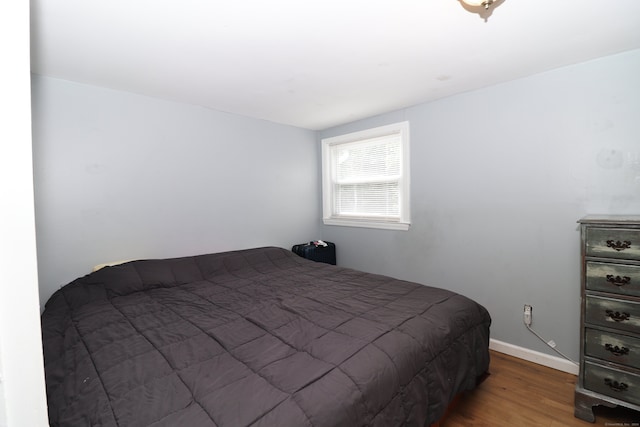 bedroom with hardwood / wood-style flooring