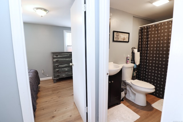 bathroom with vanity, hardwood / wood-style flooring, and toilet