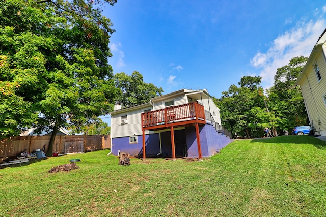 back of property with a lawn and a wooden deck