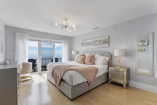 bedroom featuring access to outside, a notable chandelier, visible vents, light wood-type flooring, and baseboards