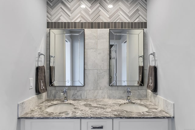 bathroom with double vanity, tasteful backsplash, and a sink