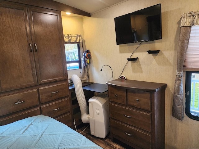 bedroom with dark wood-style flooring