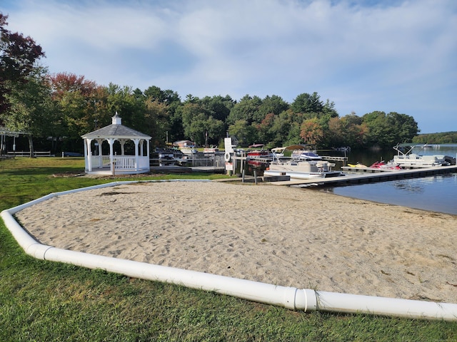 view of property's community with a gazebo, volleyball court, and a water view