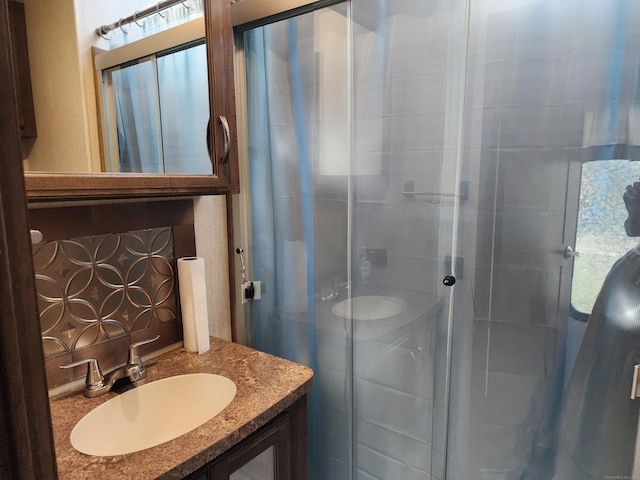 bathroom featuring vanity and a stall shower
