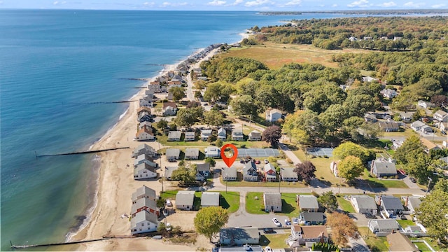 drone / aerial view featuring a water view and a beach view