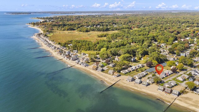 aerial view with a water view and a beach view