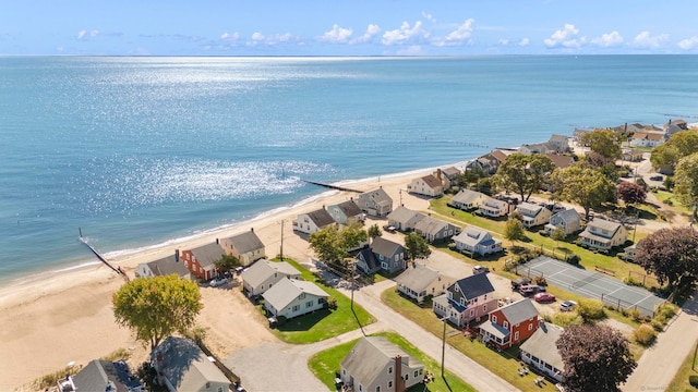 birds eye view of property with a water view and a beach view