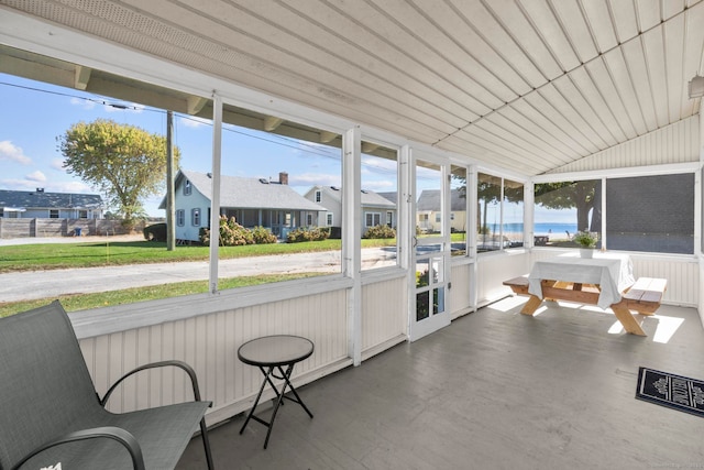 sunroom featuring a water view and a healthy amount of sunlight