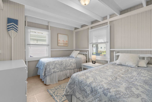 bedroom featuring wood walls and beam ceiling