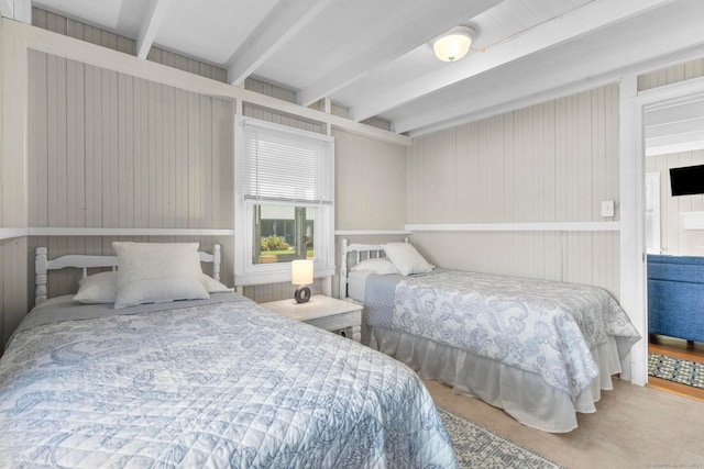 bedroom with wooden walls and beam ceiling