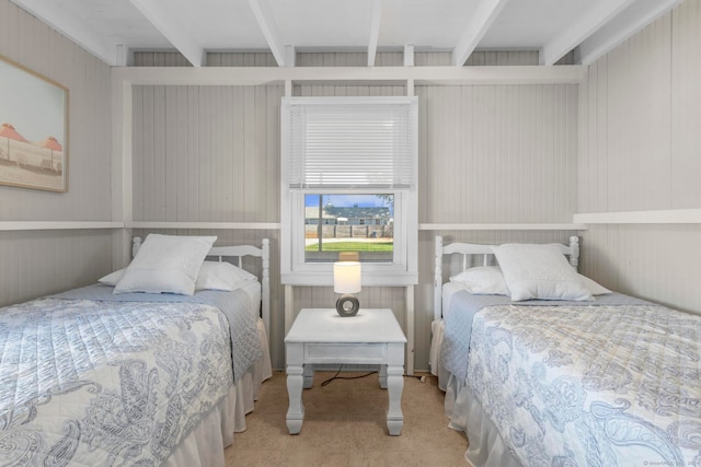 bedroom featuring wood walls and beamed ceiling