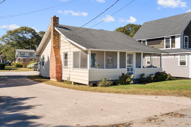 bungalow-style house featuring a sunroom