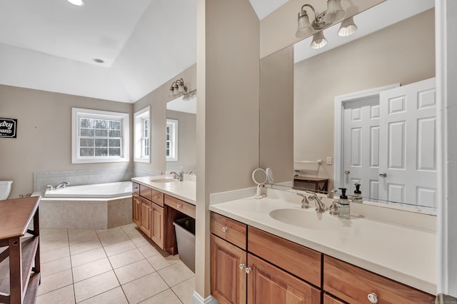 bathroom featuring tile patterned flooring, vanity, a relaxing tiled tub, and lofted ceiling