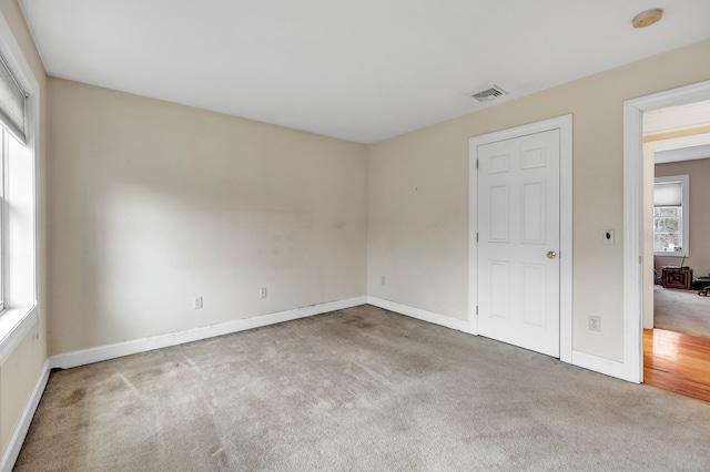 carpeted spare room with plenty of natural light