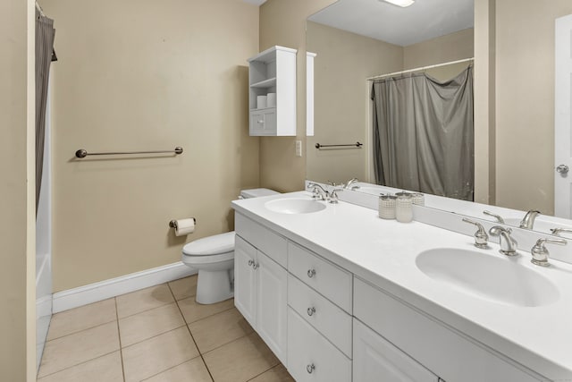 bathroom featuring toilet, vanity, tile patterned floors, and curtained shower