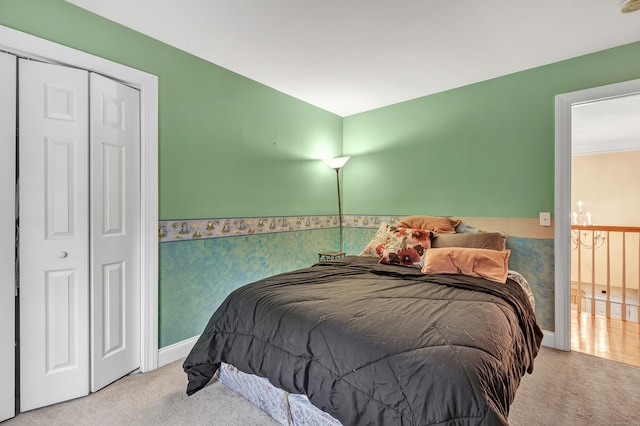 bedroom with light carpet and a closet