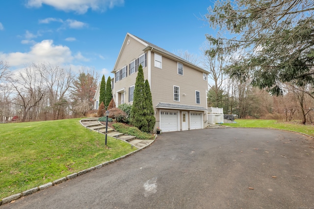 view of property exterior featuring a lawn and a garage