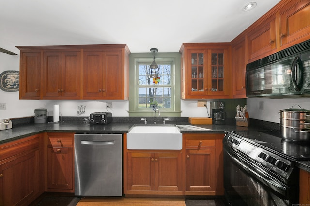 kitchen featuring hanging light fixtures, black appliances, and sink