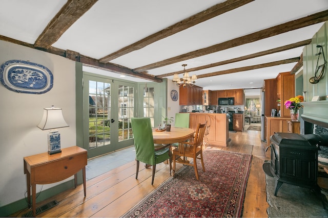 dining area featuring french doors, light hardwood / wood-style floors, and a wealth of natural light