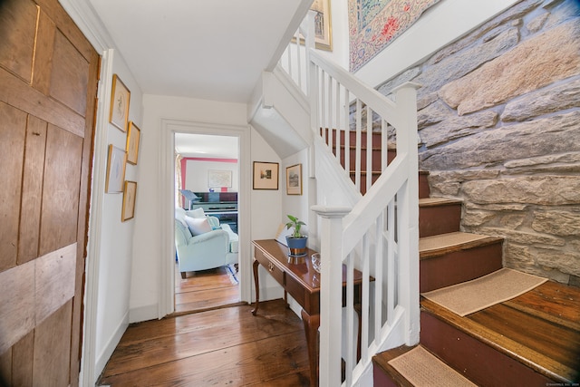 staircase featuring wood-type flooring