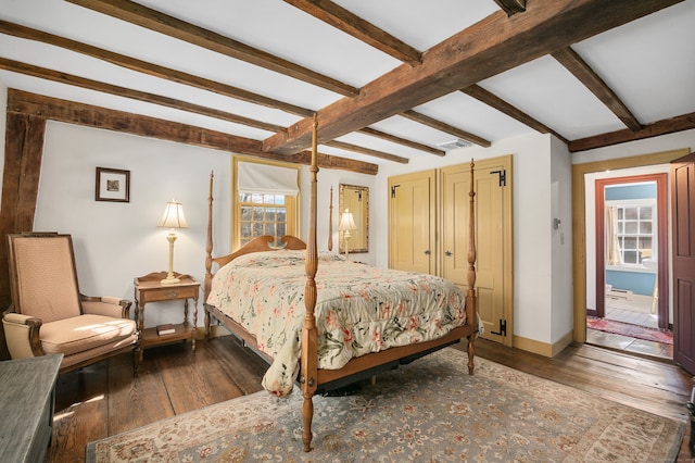 bedroom featuring multiple windows, beamed ceiling, and dark hardwood / wood-style flooring