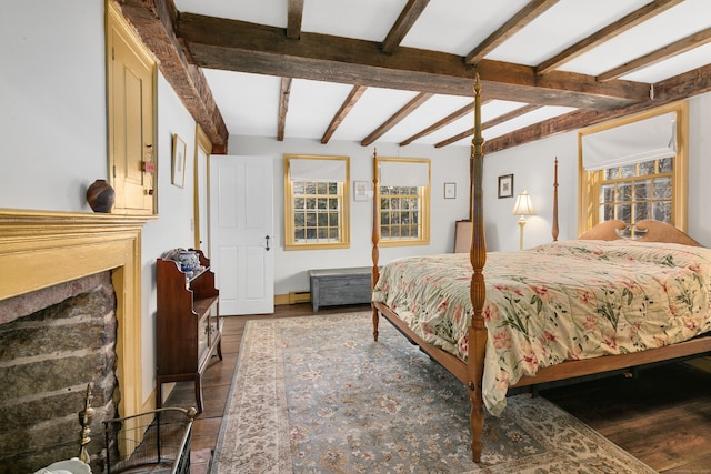 bedroom with wood-type flooring and beam ceiling