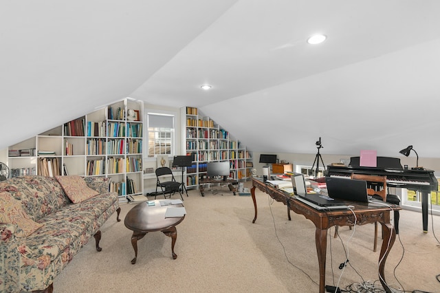 carpeted home office featuring lofted ceiling