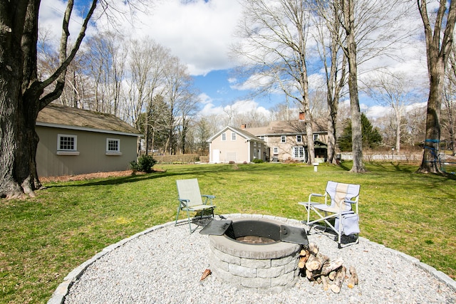 view of yard with a fire pit