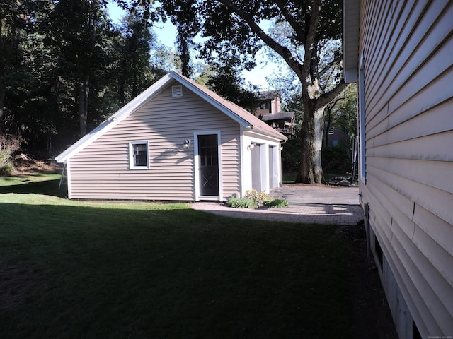 view of outbuilding featuring a yard