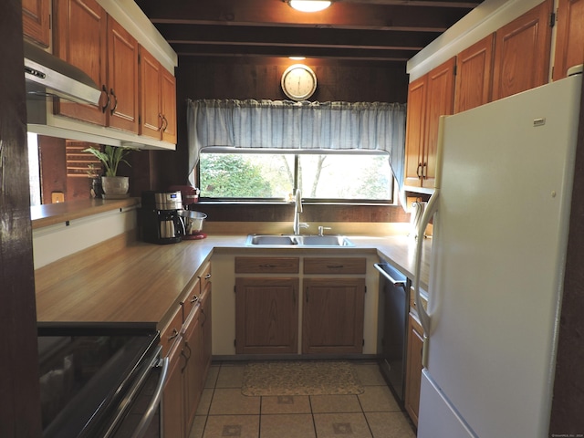 kitchen with white fridge, sink, light tile patterned flooring, stainless steel dishwasher, and stove