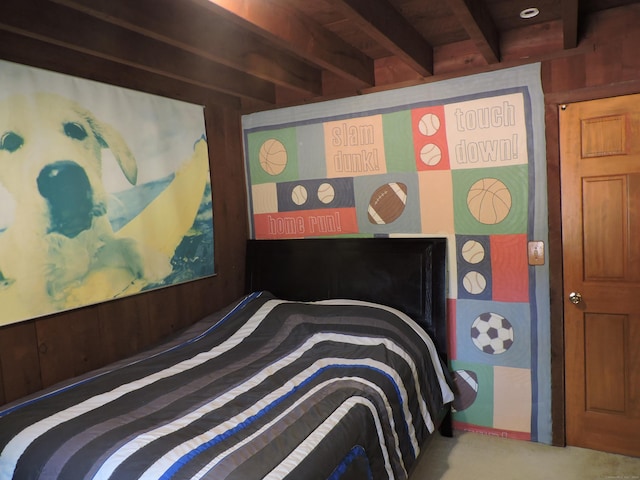 carpeted bedroom featuring wooden ceiling, wooden walls, and beam ceiling