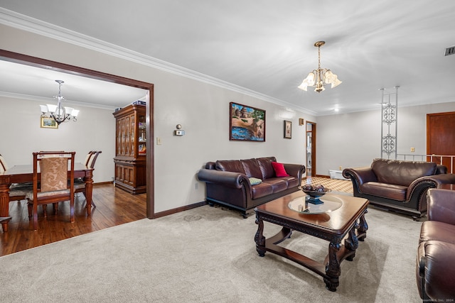 living room with wood-type flooring, a notable chandelier, and ornamental molding