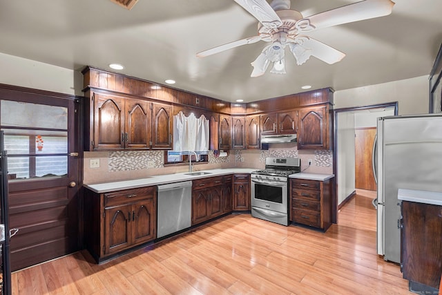 kitchen featuring ceiling fan, tasteful backsplash, light hardwood / wood-style flooring, dark brown cabinets, and stainless steel appliances