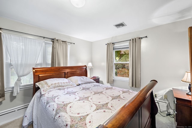 carpeted bedroom featuring baseboard heating