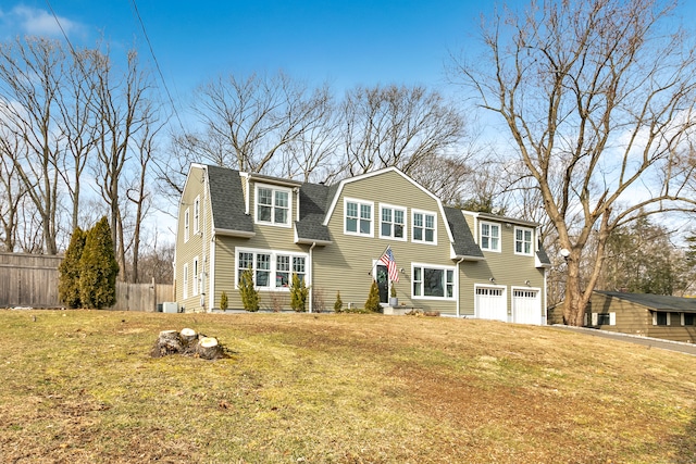 view of front of property with a front lawn and a garage