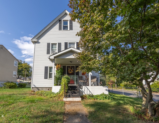 view of front of house with a porch and a front lawn