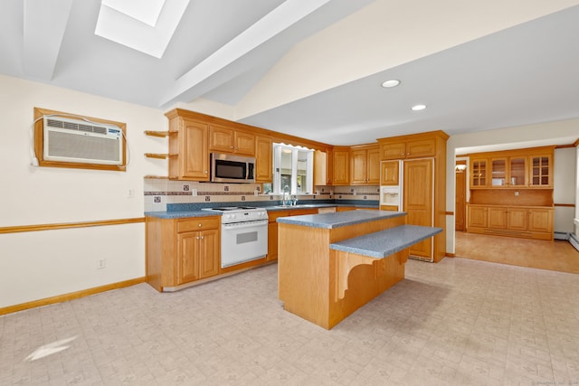 kitchen featuring a wall unit AC, lofted ceiling with skylight, white range, a kitchen bar, and a center island