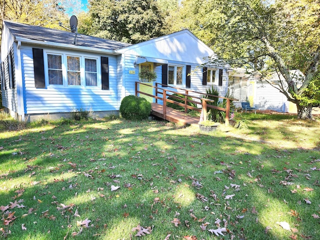 ranch-style home with a deck and a front yard