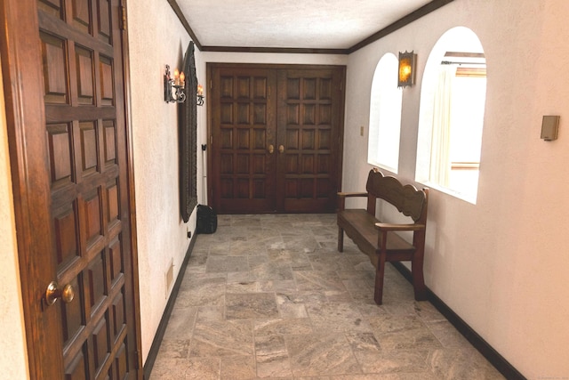 hallway with a textured ceiling and ornamental molding