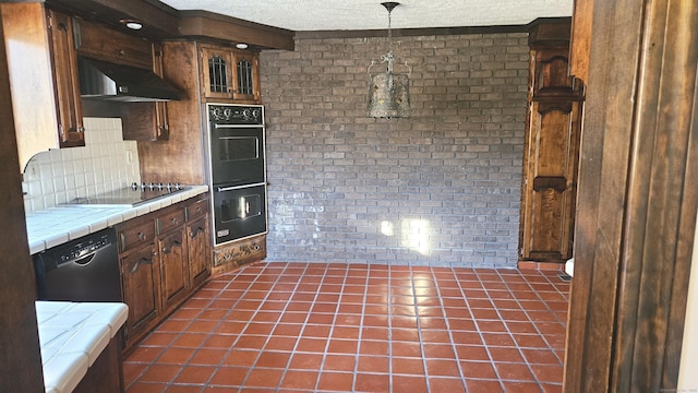 kitchen featuring tile counters, a textured ceiling, black appliances, decorative backsplash, and exhaust hood