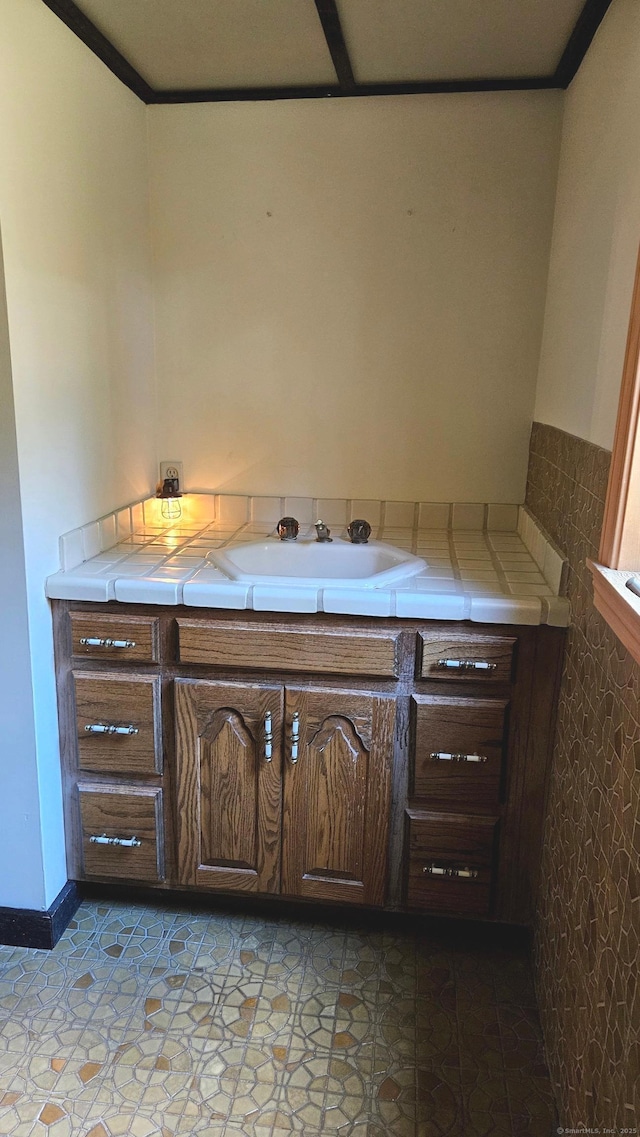 bathroom featuring ornamental molding and sink