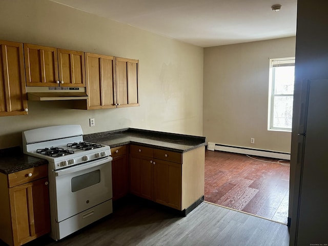 kitchen featuring white appliances, a baseboard radiator, dark hardwood / wood-style floors, and kitchen peninsula