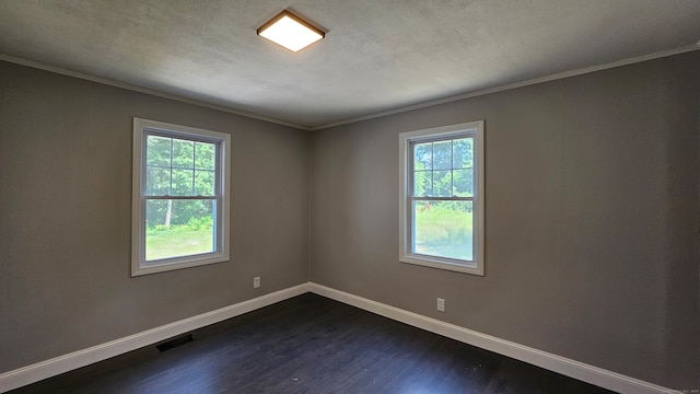 unfurnished room featuring ornamental molding, a textured ceiling, dark hardwood / wood-style flooring, and a wealth of natural light