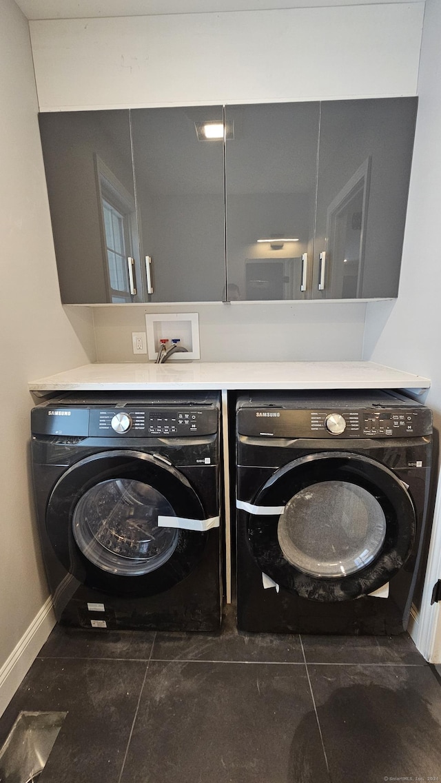107 N Hollow Rd, Hartland, CT 06027 - laundry room with separate washer and dryer, baseboards, cabinet space, and dark tile patterned floors