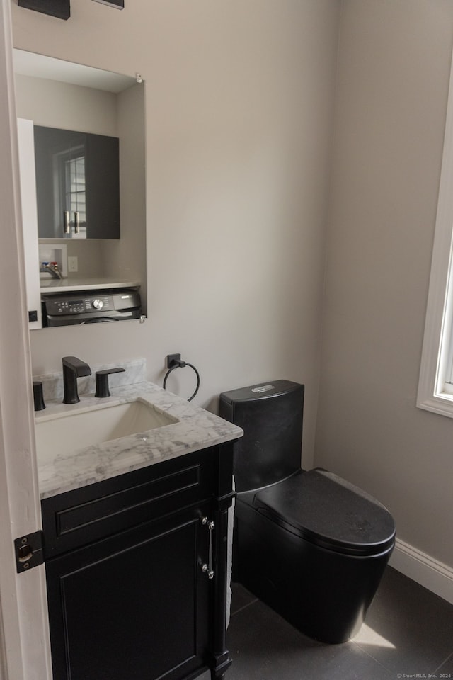 bathroom with vanity, tile patterned flooring, and toilet