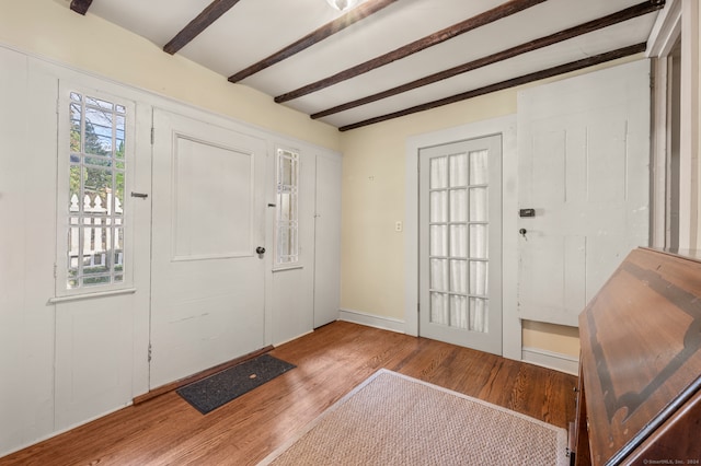 foyer with beam ceiling and wood-type flooring