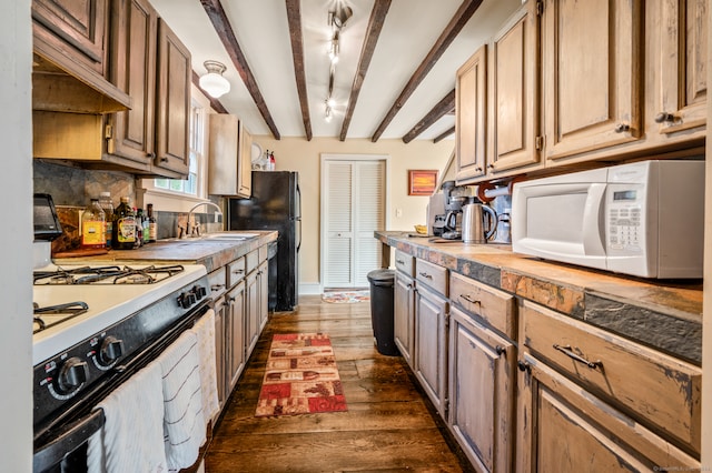 kitchen featuring custom range hood, dark wood-type flooring, white appliances, sink, and beam ceiling