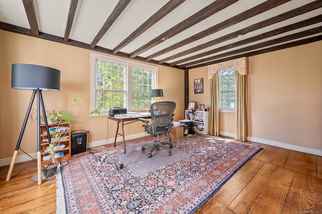 office space with beamed ceiling and light hardwood / wood-style floors